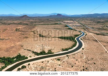 Aerial view of the Arizona Canal winding through east Mesa with the Beeline Highway to the south and Red Mountain in the distance