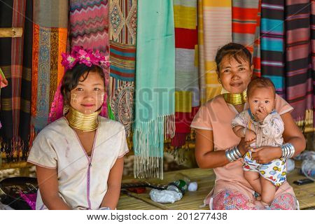 CHIANG MAI, THAILAND - July 10, 2017: Karen hill-tribe (Long Neck) woman weaving fabrics for a living at her house.