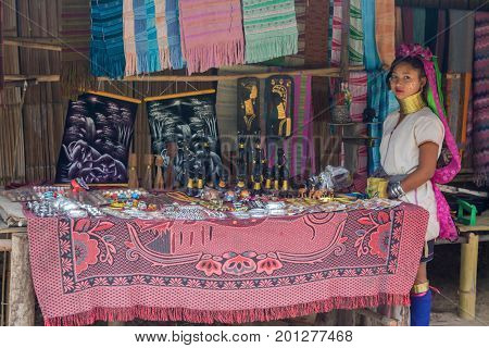 CHIANG MAI, THAILAND - July 10, 2017: Karen hill-tribe (Long Neck) woman weaving fabrics for a living at her house.
