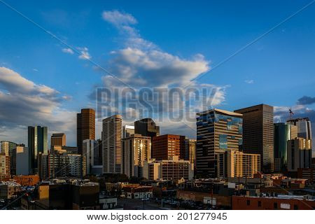 skyline of Denver Colorado during summer sunset from Blake Street