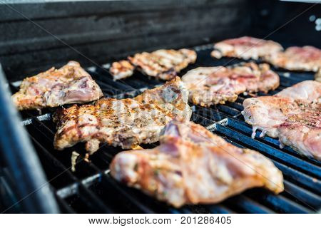 Delicious pork steaks with seasoning on the grill