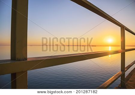 Beautiful Sunset At Rio Parana River Between The Metal Structure