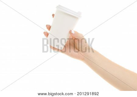 Female hands holding coffee in a cardboard glass on a white background isolation