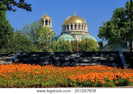 Alexander Nevsky Cathedral in Sofia framed by the trees and colorful flowers of surrounding parks, Bulgaria