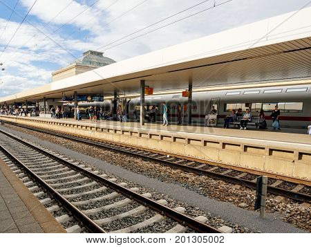 MANNHEIM GERMANY - AUG 8 2017: Large group of people waiting at the train station platform in Mannheim hauptbahnhof Train station commuting in German