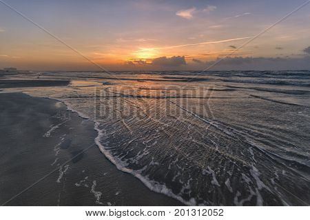 waves crashing on the gulf of Mexico at sunrise on the beaches of Port Aransas Texas