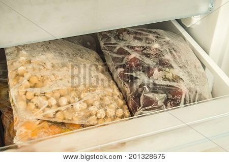 Hide food in deep freeze, get food from deep freeze, view through open door deep freeze