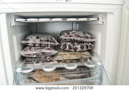 Freezing food in deep freeze, deep-freezing frozen fruit, deep freeze and food