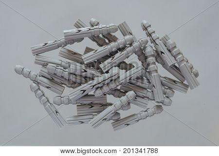 Pile of plastic dubels on white background