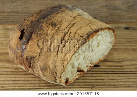 Fresh baked bread loaf on wooden table