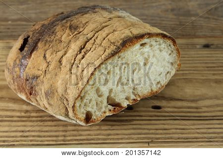 Fresh baked bread loaf on wooden table