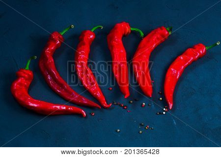 Red hot chili peppers on slate background