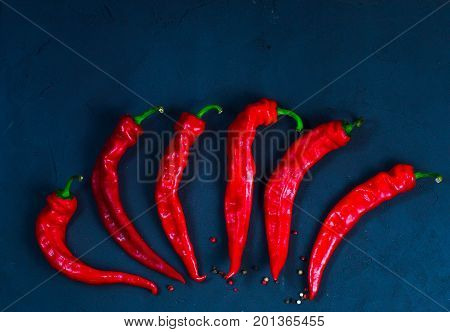 Red hot chili peppers on slate background