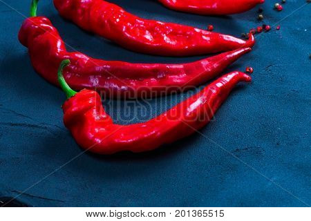 Red hot chili peppers on slate background