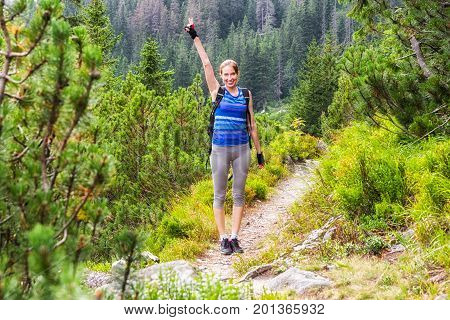 Hiker woman on hiking trail in forest at valley Koprova dolina in High tatras mountains Slovakia