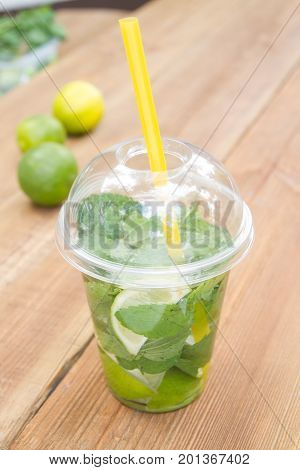 Cocktail mojito on a wooden table. Lime, mint