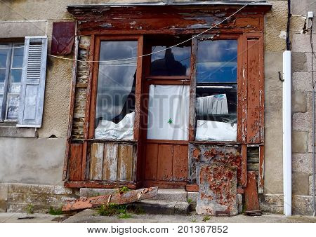 Delapidated shop closure in rural central France