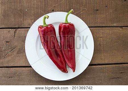 The most beautiful concept is Red fresh chilli on wood desk.
Red Hot Chili Peppers over wooden background