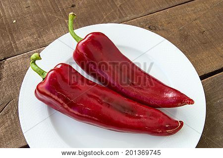 The most beautiful concept is Red fresh chilli on wood desk.
Red Hot Chili Peppers over wooden background