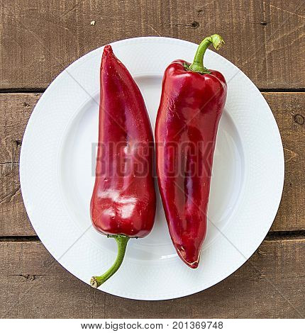 The most beautiful concept is Red fresh chilli on wood desk.
Red Hot Chili Peppers over wooden background
