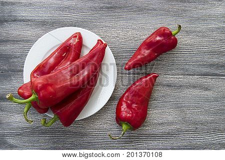 The most beautiful concept is Red fresh chilli on wood desk.
Red Hot Chili Peppers over wooden background