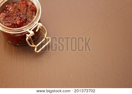 Jam in jar glass on black background