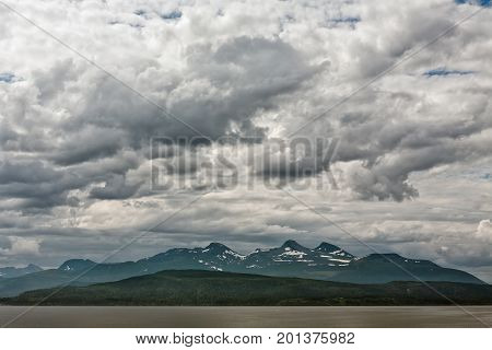 Mountains along the Romsdalsfjorden near Andalsnes under a cloudy sky Norway