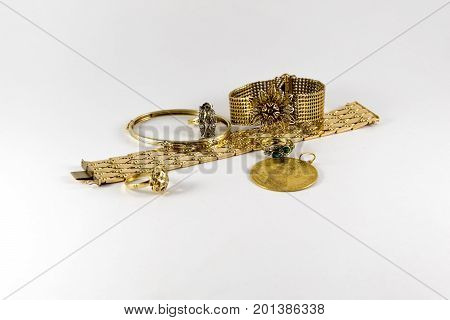 Luxurious And Expensive Golden Bracletes, Rings And Coin. Luxury Jewellery