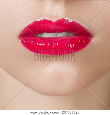 Close up chubby pink lips, an open mouth and brightly pink lipstick on lips
