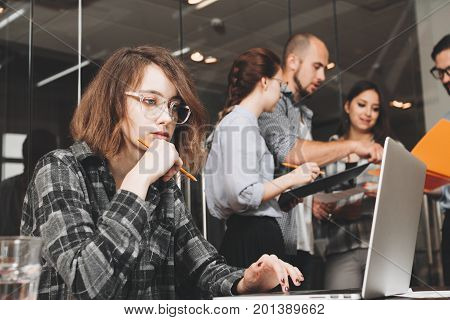 Pensive Business Woman Working Together With Team Colleagues In Modern Loft Space. Teamwork And Brai