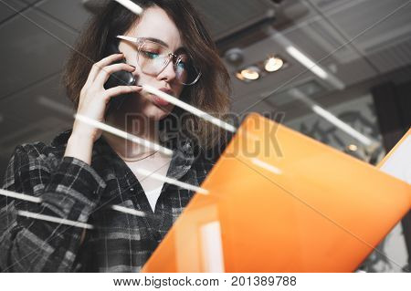 Young Pensive Business Woman In Glasses Talking Something On Phone With Manager. Photo Of Close-up F