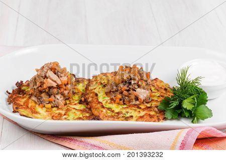 Draniki with mushroom caviar filmed in decor