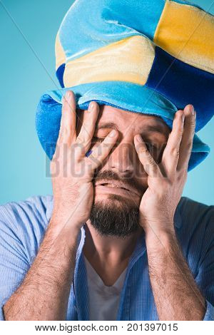 The emotions on face of football fan with hat over blue background