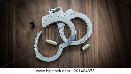 Golden Bullet Shells And Police Handcuffs For Catching Criminals Half Opened And Fighting Crime Layi
