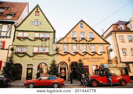 Rothenburg ob der Tauber, December 30, 2017: Decorated in a Christmas style car next to a toy store. Kathe Wohlfahrt Christmas decorations and toy shop. A popular toy store in Germany.