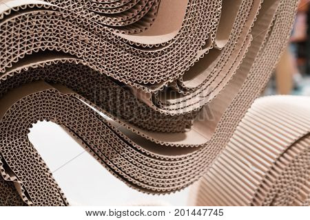 Roll of wavy craft paper folded in random. Single faced corrugated paper best useful for decoration. Selective focus