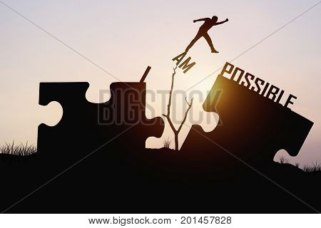 man jumping over jigsaw opposite possible shore concept as believe and faith to conncet business