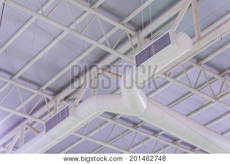HVAC duct air conditioner ventilation pipes system in white insulation material hanging from the ceiling inside new building.