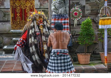 Bali, Indonesia - August 15, 2017: A regal character in a traditional Barong ceremony in Bali. The depiction of the battle between good and evil intertwines local history and mythology to create a parable for all ages.