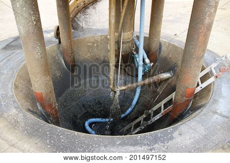 Pump sump in the tank of a sewage treatment plant, which was emptied for work