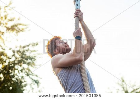 Climed up. Stronger athlete climed up and looking up.