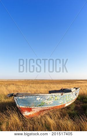 old wooden boat in the field. Beautiful scenic view