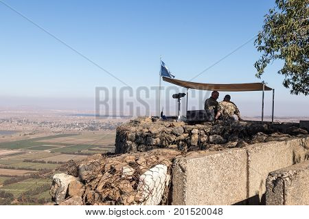 Golan Heights Israel August 27 2017 : The peacekeeper from the UN forces looks toward Syria being on a fortified point on Mount Bental on the Golan Heights in Israel.