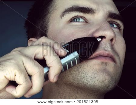 Man Removing Nose Hair