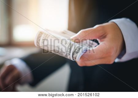 Business man holding dollar bills Saving money concept