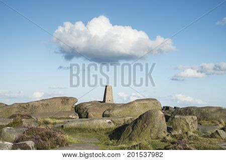 Summer Landscape Image Of Trig Point On Top Of Stanage Edge In Peak District