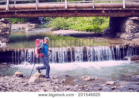 Hiking in the mountains with a backpack in the summer.