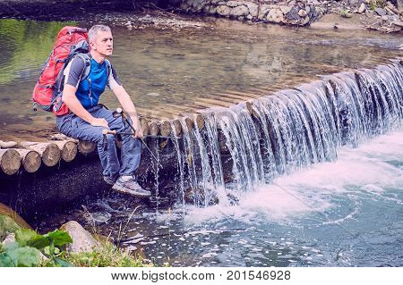 Hiking in the mountains with a backpack in the summer.