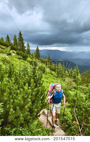 Hiking in the mountains with a backpack in the summer.