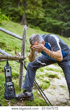 Hiking in the mountains with a backpack in the summer.
